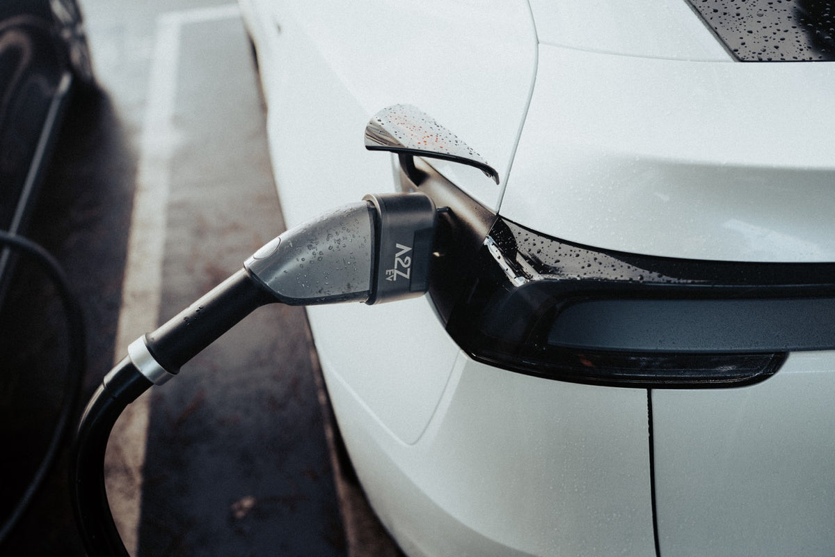 EV charging adapter plugged into a car